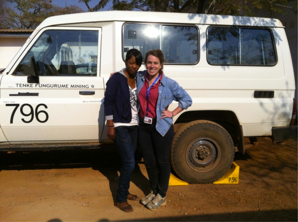 Debra and I in front of a Tenke Fungurume Mining vehicle before going to the field for the day, in front of the RAP (Resettlement Action Plan) office at Base Camp